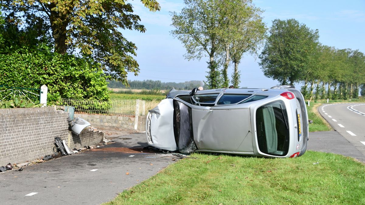 Auto ramt muurtje en komt op z'n kant terecht