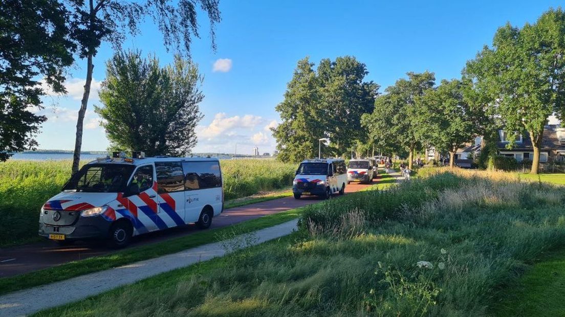 Politiebussen rijden voor de stoet uit.