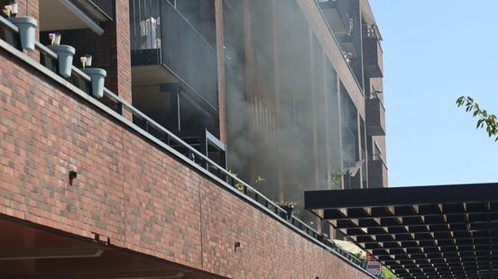 Vlammen en zwarte rookwolken bij brand in appartementencomplex Home