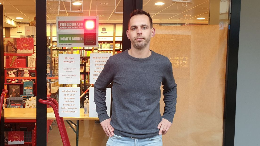 Sander Jongejan voor de deur van zijn boekhandel
