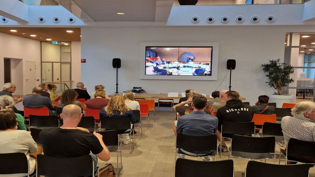 De raadzaal in het Lochemse gemeentehuis is te klein voor alle insprekers en daarom zitten er in de centrale hal ook mensen.