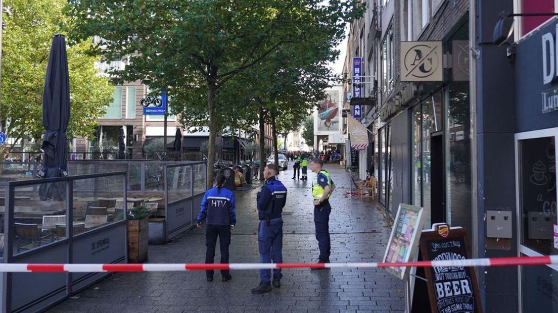 Winkelend publiek wordt op afstand gehouden.