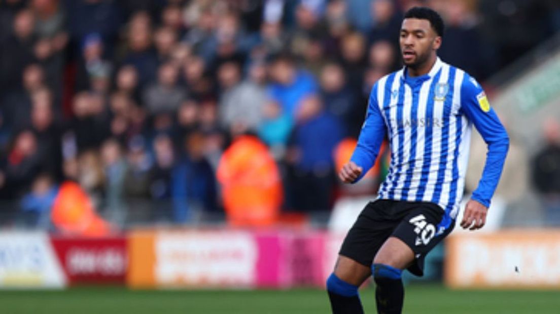 Sylla Sow, hoofdpersoon in een bizarre soap, in het shirt van Sheffield Wednesday