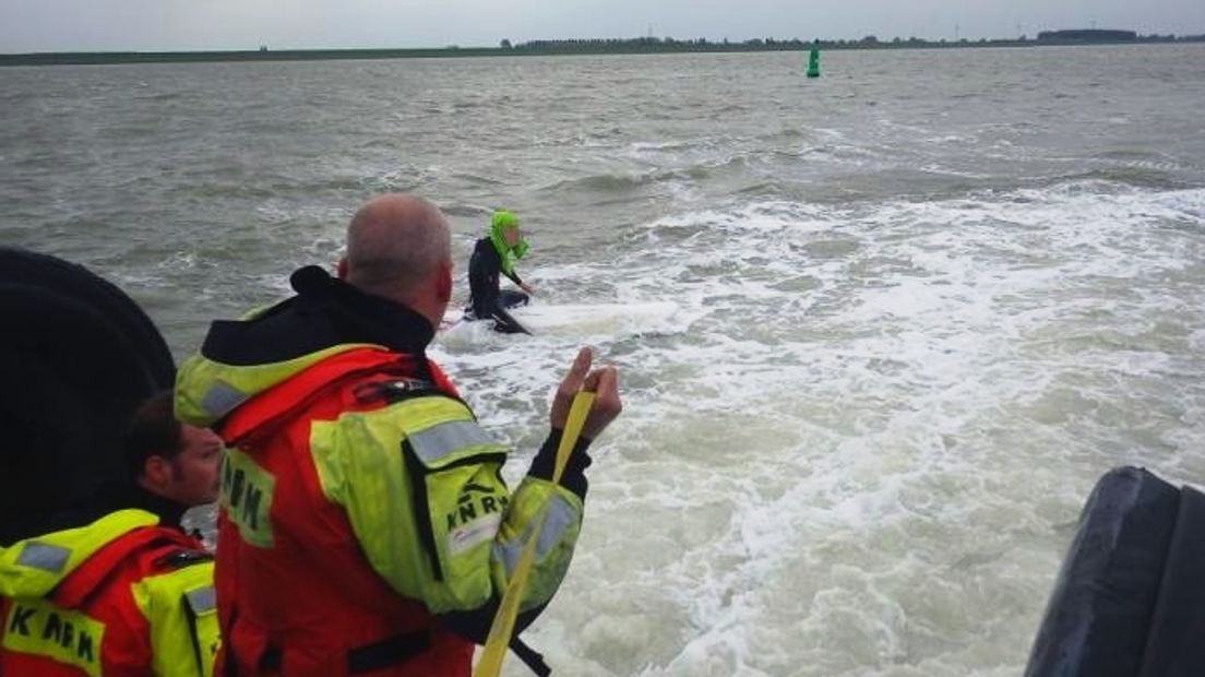 Reddingswerkers van de KNRM Breskens halen surfer aan boord van de reddingsboot Zeemanshoop