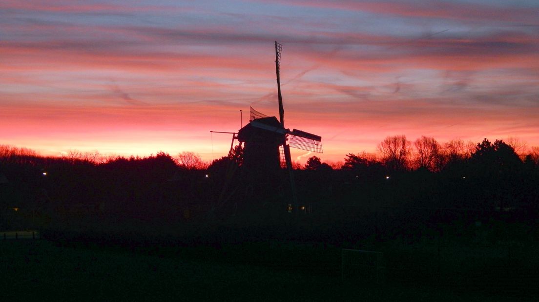 Zon gaat onder achter de molen van Domburg
