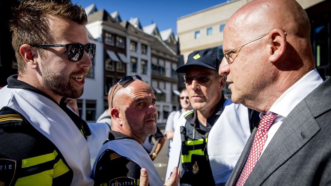 Agenten in gesprek met minister Grapperhaus tijdens een manifestatie in Den Haag